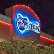 toby keith "i love this bar and grill" sign lit at night